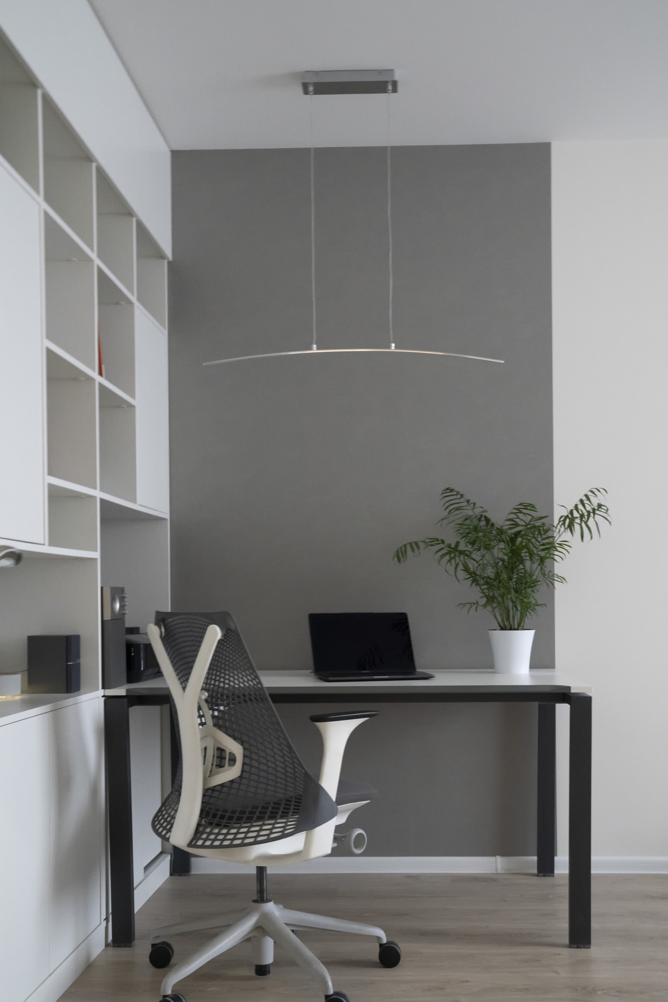 company-office-corner-with-a-modern-desk-orthopedic-chair-up-to-date-computer-and-green-flowerpot.jpg
