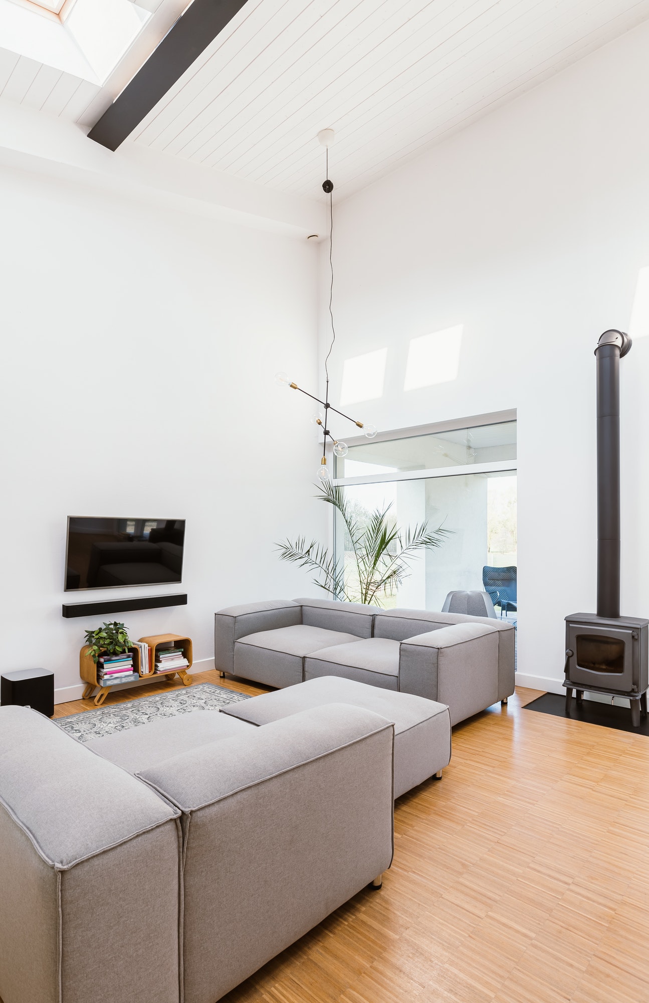 vertical-view-of-elegant-living-room-interior-with-grey-sofa-tv-and-retro-fireplace.jpg